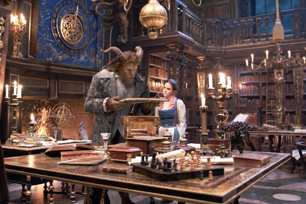 The Beast (Dan Stevens) and Belle (Emma Watson) in the castle library in Disney's BEAUTY AND THE BEAST, a live-action adaptation 